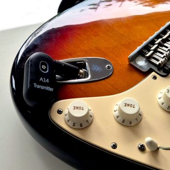 Wireless guitar transmitter installed A14 wireless audio transmitter plugged into an electric guitar