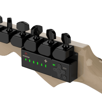 TronicalTune automatic guitar tuner mounted behind a six-in-line guitar headstock with black motorized tuning pegs and Strat keys