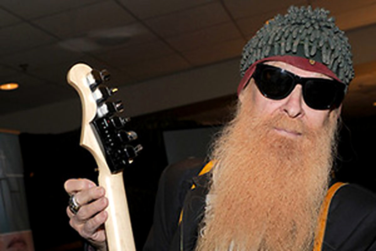 Guitarist holding an electric guitar while managing guitar tuning drift before a live performance