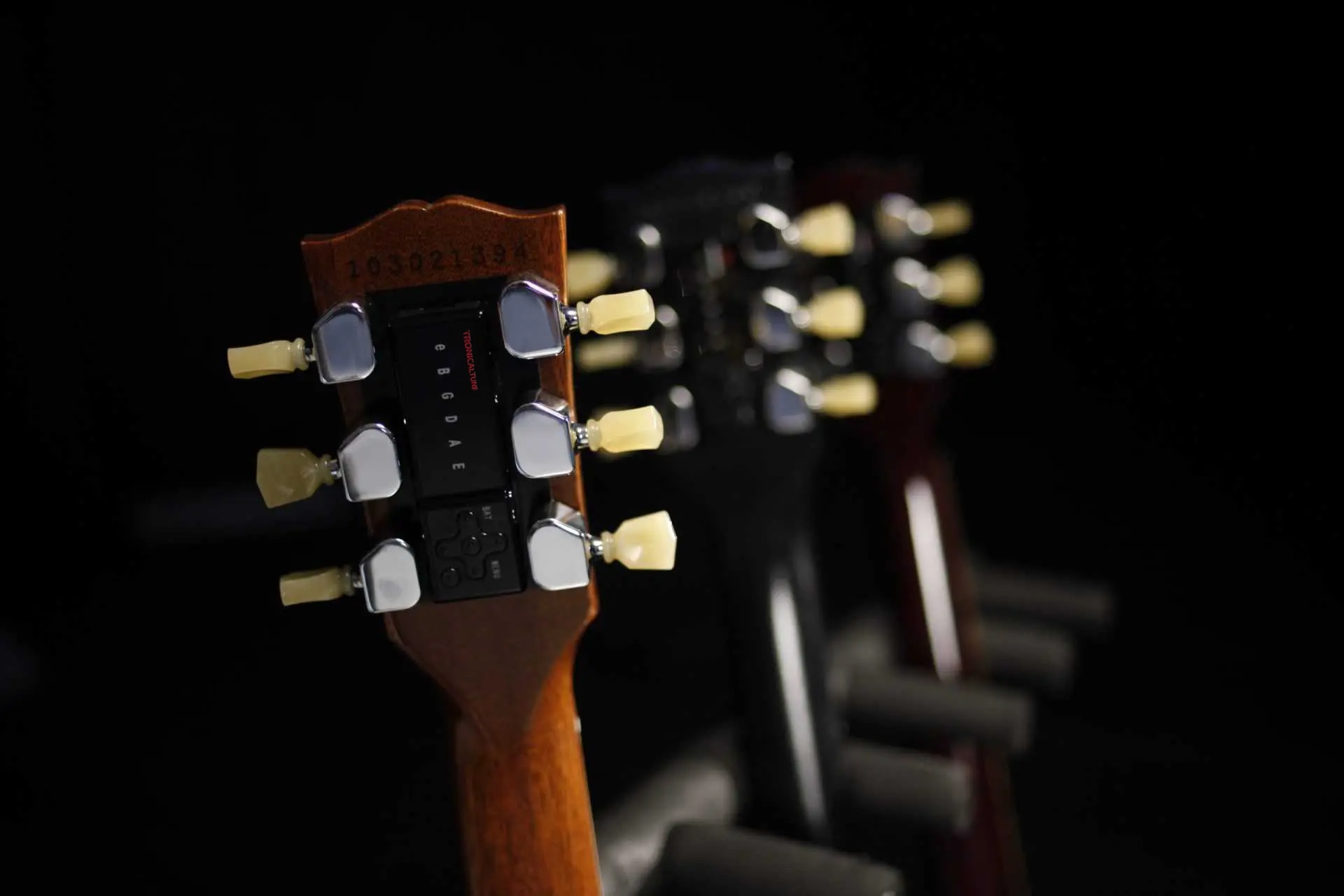 TronicalTune automatic guitar tuning system with red logo on a guitar headstock