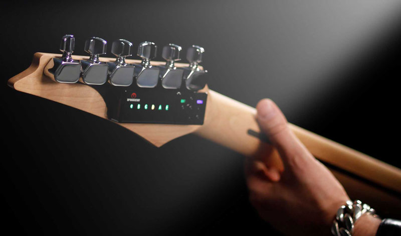 Guitar tuner - automatic tuning with TronicalTune TronicalTune automatic guitar tuner mounted behind a six-in-line electric guitar headstock